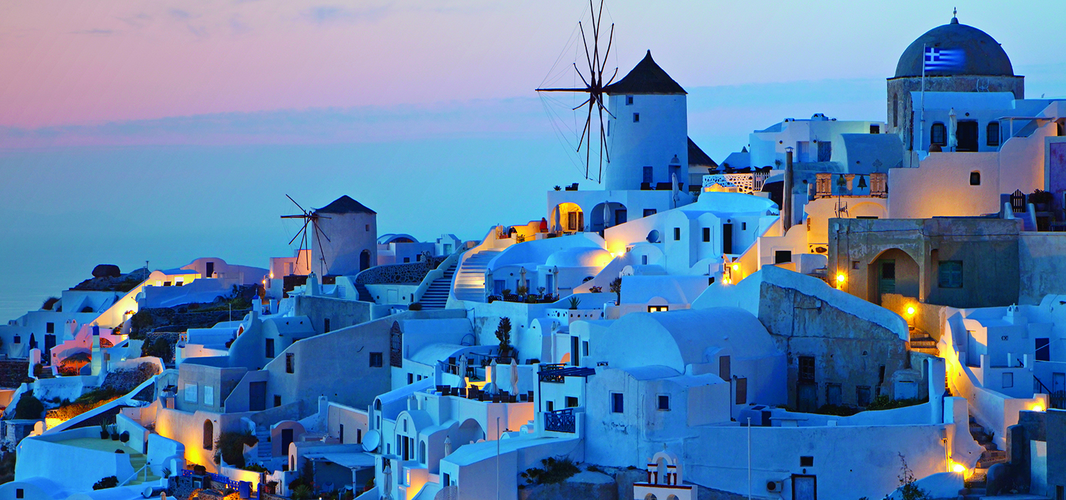 Greece: the Cyclades yacht charter itinerary. The famous white buildings of the Cyclades at nighttime, best appreciates from a luxury yacht charter